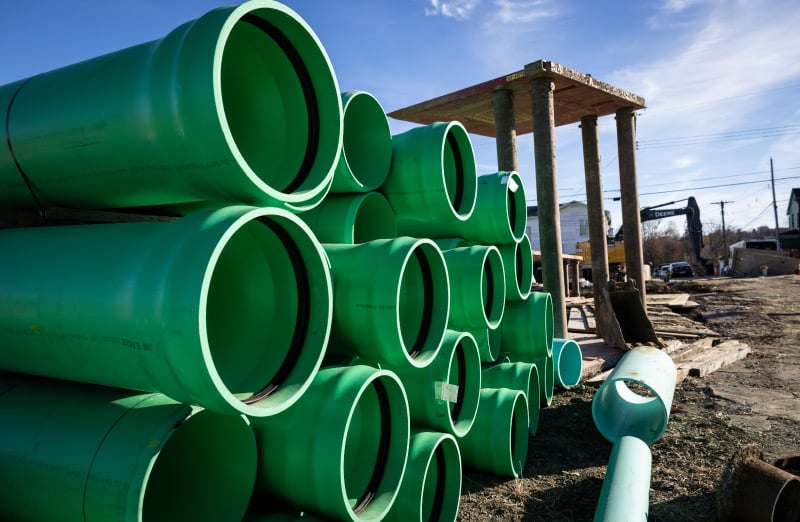 stack of pipes waiting for installation on job site