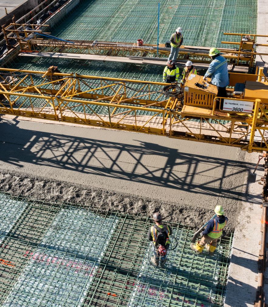 construction workers pouring concrete